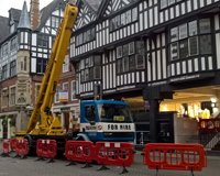 Cherry Picker fenced off outside of a tudor styled building.