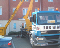 Cherry Picker preparing for work outside a set of flats.